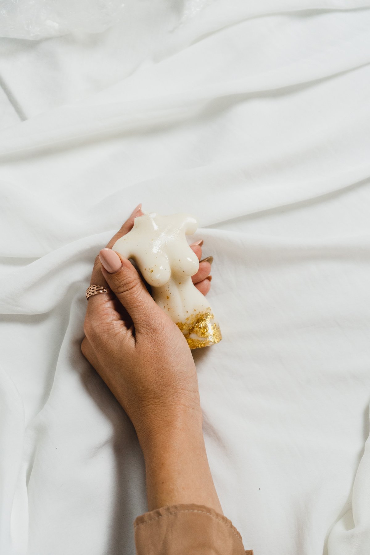 Woman Holding a Body Shaped Candle